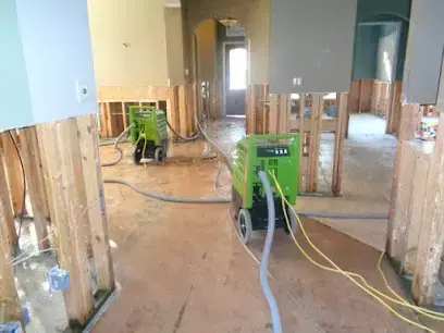 Drying equipment set up in a Perris home after water came through the floor and walls